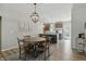 Bright dining area features a rustic table, decorative chandelier, and adjacent modern kitchen at 3613 Lehigh Ave, Westfield, IN 46074