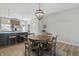 Charming dining area featuring modern light fixture, wood flooring, and open kitchen concept at 3613 Lehigh Ave, Westfield, IN 46074