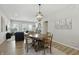 Cozy dining area with wood table set and chandelier, seamlessly connected to the living room at 3613 Lehigh Ave, Westfield, IN 46074