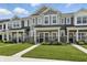 Attractive townhomes featuring covered porches, stone accents, and a lush, green lawn at 3613 Lehigh Ave, Westfield, IN 46074