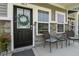Close-up of cozy porch with seating, decorative wreath, and stone accents on home's facade at 3613 Lehigh Ave, Westfield, IN 46074
