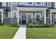 Inviting front porch featuring stylish chairs and lush landscaping in front of the townhome at 3613 Lehigh Ave, Westfield, IN 46074