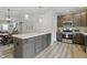 Charming kitchen features stainless steel appliances, expansive island, and wood grain flooring at 3613 Lehigh Ave, Westfield, IN 46074