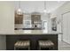 Beautiful kitchen with stainless steel appliances, speckled quartz countertops and cozy breakfast bar at 3613 Lehigh Ave, Westfield, IN 46074