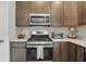 Well-equipped kitchen features modern stainless appliances and ample wood cabinet space at 3613 Lehigh Ave, Westfield, IN 46074