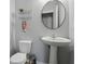 Classic powder room with pedestal sink, round mirror, and stylish wall decor at 3613 Lehigh Ave, Westfield, IN 46074