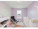 Bedroom featuring a crib, chair, and changing station with light purple walls and a window at 3643 Thomas Jefferson St, Westfield, IN 46074