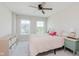 Bright bedroom with a ceiling fan, two windows, neutral walls and furnishings at 3643 Thomas Jefferson St, Westfield, IN 46074