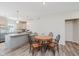 Cozy dining area with a wooden table, four chairs, and view of the kitchen with granite countertops at 3643 Thomas Jefferson St, Westfield, IN 46074