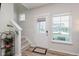 Bright entryway featuring a staircase, a front door with sidelight, and a large window for natural light at 3643 Thomas Jefferson St, Westfield, IN 46074