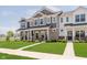 Charming townhome exteriors with stone accents, pristine lawns, and inviting walkways in a serene neighborhood at 3643 Thomas Jefferson St, Westfield, IN 46074