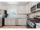 Modern kitchen with stainless steel appliances, gray cabinets, granite countertops, and a gas range at 3643 Thomas Jefferson St, Westfield, IN 46074