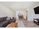 Open-concept living room flowing into dining area, with a comfortable sofa and contemporary decor at 3643 Thomas Jefferson St, Westfield, IN 46074