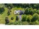 Expansive aerial view of home on large lot with in-ground pool and surrounding trees at 3715 Pitkin Rd, Martinsville, IN 46151