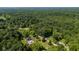 Aerial view of home nestled in a lush, green forest with a blue swimming pool at 3715 Pitkin Rd, Martinsville, IN 46151