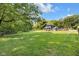 Large grassy backyard featuring mature trees, fence, above-ground pool, and wooden deck at 3715 Pitkin Rd, Martinsville, IN 46151