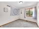Bright bedroom featuring a window, carpeted floor, and a decorative wall hanging at 3715 Pitkin Rd, Martinsville, IN 46151