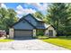 Charming home with a well-maintained lawn, a vibrant green door, and beautiful landscaping at 3715 Pitkin Rd, Martinsville, IN 46151