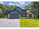 Charming two-story home boasts a lush green lawn, mature trees, and a welcoming green front door at 3715 Pitkin Rd, Martinsville, IN 46151