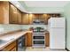 Functional kitchen features stainless steel appliances, wood cabinets, and ample counter space at 3715 Pitkin Rd, Martinsville, IN 46151