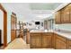 Open-concept kitchen featuring wooden cabinets, a breakfast bar, and seamless transition into the living area at 3715 Pitkin Rd, Martinsville, IN 46151