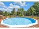 Above ground pool with surrounding wooden deck and fencing, set on lush green lawn at 3715 Pitkin Rd, Martinsville, IN 46151