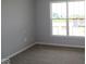 A well-lit bedroom features a large window overlooking the neighborhood and neutral carpeting at 3824 Dutton Dr, Bargersville, IN 46106