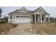 New home features a two-car garage, covered front porch, beige siding, white trim, and gabled roof with architectural details at 3824 Dutton Dr, Bargersville, IN 46106