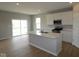 Modern kitchen with stainless steel appliances, quartz countertops and an island overlooks the living space at 3824 Dutton Dr, Bargersville, IN 46106