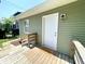 This covered back porch features wood floors and a welcoming doormat at 3835 N Kenwood Ave, Indianapolis, IN 46208