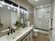 Modern bathroom with double sinks, updated fixtures, and stylish tile shower at 3835 N Kenwood Ave, Indianapolis, IN 46208