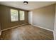 Bedroom featuring neutral walls, luxury vinyl floors, and natural lighting at 3835 N Kenwood Ave, Indianapolis, IN 46208