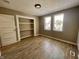 Bedroom features a closet, wood floors and neutral paint, bathed in natural light from the windows at 3835 N Kenwood Ave, Indianapolis, IN 46208