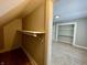 View of a closet and into an adjacent bedroom with light grey walls and white trim at 3835 N Kenwood Ave, Indianapolis, IN 46208