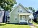 Charming exterior of home featuring neutral siding, white trim, covered porch, and well-maintained landscaping at 3835 N Kenwood Ave, Indianapolis, IN 46208