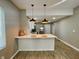 Open-concept kitchen featuring counter seating, stainless steel appliances, and lots of natural light at 3835 N Kenwood Ave, Indianapolis, IN 46208