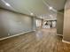 Spacious living room with open floor plan, wood flooring, and modern recessed lighting at 3835 N Kenwood Ave, Indianapolis, IN 46208
