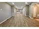 Large living room with open floor plan, wood flooring, and seamless flow to the kitchen and staircase at 3835 N Kenwood Ave, Indianapolis, IN 46208