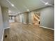 Bright living room with open floor plan, wood flooring, and seamless flow to the kitchen and staircase at 3835 N Kenwood Ave, Indianapolis, IN 46208