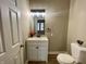 This half-bath features a modern vanity, vessel sink, and tasteful decor for guests at 3835 N Kenwood Ave, Indianapolis, IN 46208
