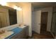 Bathroom with a double sink vanity, contemporary lighting, and a doorway leading to a walk-in closet and shower area at 3993 Bozeman Way, Bargersville, IN 46106