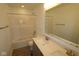 Bathroom featuring a double sink vanity with light countertop and a shower-tub combo with tiled walls at 3993 Bozeman Way, Bargersville, IN 46106