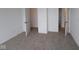 Carpeted bedroom with three doorways and a closet, providing ample space for storage and easy access at 3993 Bozeman Way, Bargersville, IN 46106