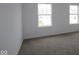 Bedroom with neutral carpet, white walls, and natural light from two windows showing a neighboring home at 3993 Bozeman Way, Bargersville, IN 46106