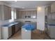Well-lit kitchen featuring gray cabinets, stainless steel appliances and a central island with countertop and sink at 3993 Bozeman Way, Bargersville, IN 46106