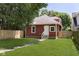 Well-kept backyard with a lush green lawn, brick walkway, and a charming two-story home at 4226 Cornelius Ave, Indianapolis, IN 46208