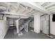 Unfinished basement with painted brick walls, exposed ceiling, and a stairway to upper level at 4226 Cornelius Ave, Indianapolis, IN 46208