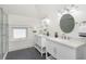 Elegant bathroom with double vanities, round mirrors, and modern fixtures, exuding sophistication at 4226 Cornelius Ave, Indianapolis, IN 46208
