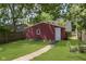 Exterior shot of a single-car garage with a well-manicured lawn and stone walkway at 4226 Cornelius Ave, Indianapolis, IN 46208
