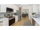 Bright kitchen with stainless steel appliances, white cabinetry, and stylish backsplash at 4226 Cornelius Ave, Indianapolis, IN 46208